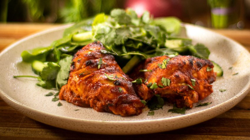 A delicious BBQ style chili chicken recipe made with smoky bell pepper chili based sauce. Roasted using one pan and a blender. It also adapts well to a closed lid style BBQ. Simple to make, and if you make this the day before, it’s even better as the sauce works like a marination. The sauce is made using red bell peppers or capsicums, they are charred black and peeled. Watch the video to see how to peel them. Make extra as these are delish in salads or any meal. Make sure you cook it long enough to get a few black burnt bits on top. So tasty! Serve it with a crispy fresh salad, rice or potatoes. Enjoy my smoky bell pepper chili chicken.